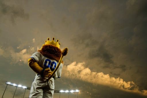 Kansas City Royals mascot Sluggerrr stands for the national anthem before a baseball game against the Arizona Diamondbacks, Wednesday, Sept. 9, 2026, in Kansas City, Mo. (AP Photo/Charlie Riedel) (AP Photo/Charlie Riedel)