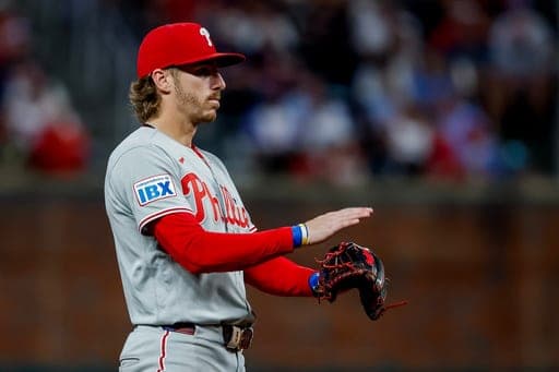 Philadelphia Phillies third baseman Bryson Stott gestures between Atlanta Braves batters during the fourth inning of a baseball game, Saturday, Sept. 12, 2026, in Atlanta. (AP Photo/Erik S. Lesser) (AP Photo/Erik S. Lesser)