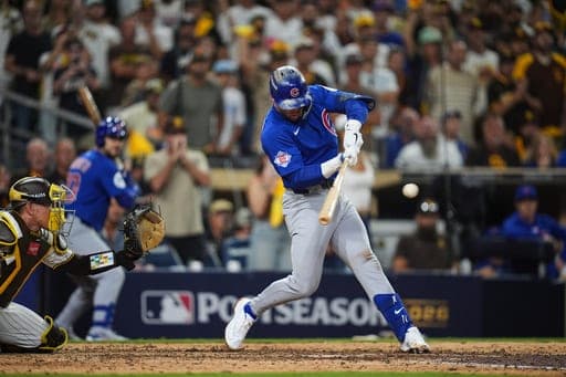 Chicago Cubs second baseman Nico Hoerner hits a double against the San Diego Padres in the 9th inning of Game 2 of the National League Wild Card baseball playoff series Wednesday, Sept. 30, 2026, in San Diego. (AP Photo/Gregory Bull) (AP Photo/Gregory Bull)