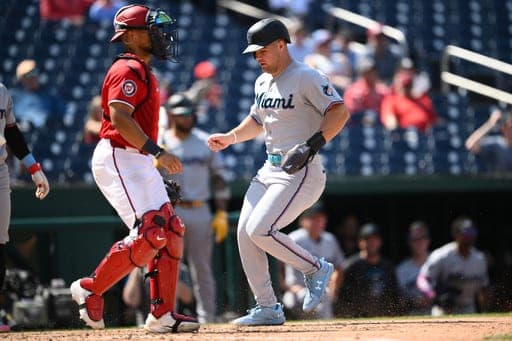 Miami Marlins' Jakob Marsee, right, steals home against Washington Nationals catcher Harry Ford, left, during the ninth inning of a baseball game, Sunday, Aug. 30, 2026, in Washington. (AP Photo/Nick Wass) (AP Photo/Nick Wass)