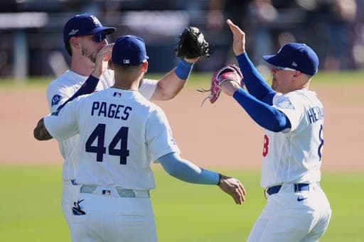 Los Angeles Dodgers left fielder Kiké Hernández, right, celebrates with center fielder Andy Pages (44) and right fielder Kyle Tucker after the Dodgers defeated the Atlanta Braves 5-3 in Game 1 of a National League Division Series baseball game Saturday, Oct. 3, 2026, in Los Angeles. (AP Photo/Jae C. Hong) (AP Photo/Jae C. Hong)