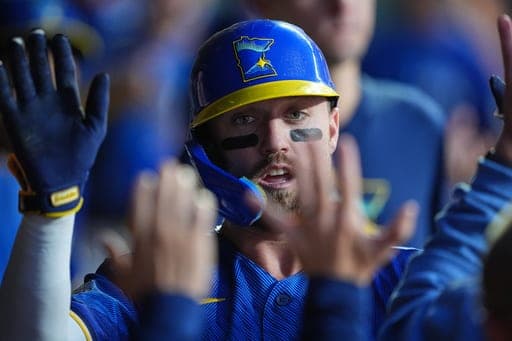 Minnesota Twins' Kody Clemens celebrates in the dugout after scoring during the second inning of a baseball game against the Cleveland Guardians, Friday, Sept. 11, 2026, in Minneapolis. (AP Photo/Ellen Schmidt) (AP Photo/Ellen Schmidt)