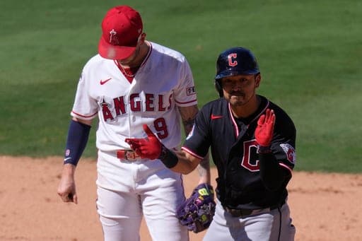 Cleveland Guardians' Steven Kwan, right, celebrates after hitting an RBI ground run double as Los Angeles Angels shortstop Zach Neto stands by during the ninth inning of a baseball game Wednesday, Aug. 26, 2026, in Anaheim, Calif. (AP Photo/Mark J. Terrill) (AP Photo/Mark J. Terrill)