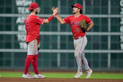 Los Angeles Angels' Zach Neto, left, and Adam Frazier celebrate the team's win over the Houston Astros in a baseball game Thursday, Aug. 20, 2026, in Houston. (AP Photo/Eric Christian Smith) (AP Photo/Eric Christian Smith)
