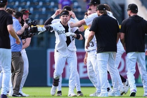 Colorado Rockies' Brett Sullivan, center, is congratulated after his walkoff RBI single by teammates in the 11th inning of a baseball game against the Baltimore Orioles Wednesday, Sept. 2, 2026, in Denver. (AP Photo/David Zalubowski) (AP Photo/David Zalubowski)