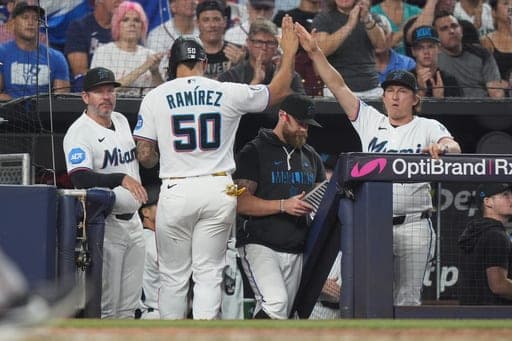 Miami Marlins' Agustín Ramírez (50) is congratulated after scoring on a single hit by Griffin Conine during the fourth inning of a baseball game against the Atlanta Braves, Saturday, Sept. 26, 2026, in Miami. (AP Photo/Lynne Sladky) (AP Photo/Lynne Sladky)