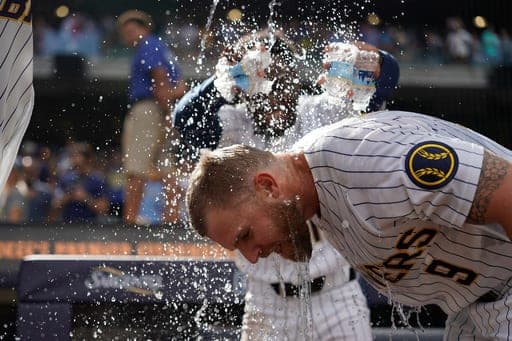 Milwaukee Brewers' Jake Bauers (9) is doused by Luis Lara after a baseball game against the Atlanta Braves, Saturday, Aug. 22, 2026, in Milwaukee. (AP Photo/Aaron Gash) (AP Photo/Aaron Gash)
