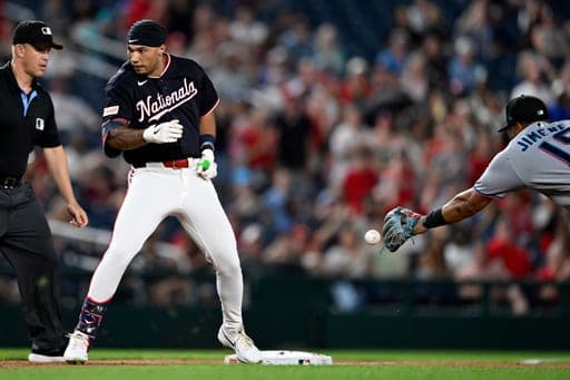 Washington Nationals' Daylen Lile is safe at third base after driving in Nationals' Dylan Crews on an RBI triple during the seventh inning of a baseball game against the Miami Marlins, Friday, Aug. 28, 2026, in Washington. (AP Photo/John McDonnell) (AP Photo/John McDonnell)