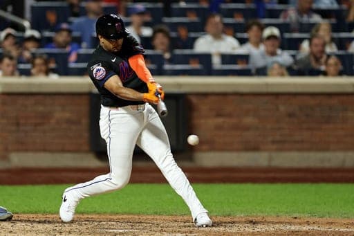 New York Mets' Christopher Morel hits into a fielders choice to score the winning run during the 10th inning of a baseball game against the Milwaukee Brewers on Tuesday, Aug. 25, 2026, in New York. (AP Photo/Adam Hunger) (AP Photo/Adam Hunger)
