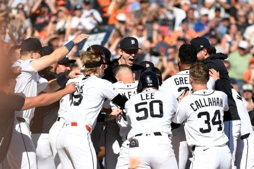 Detroit Tigers mob teammate Eduardo Valencia after he hit a game-winning two-run home run in the ninth inning of a baseball game against the Pittsburgh Pirates, Saturday, Sept. 26, 2026, in Detroit. (AP Photo/Jose Juarez) (AP Photo/Jose Juarez)