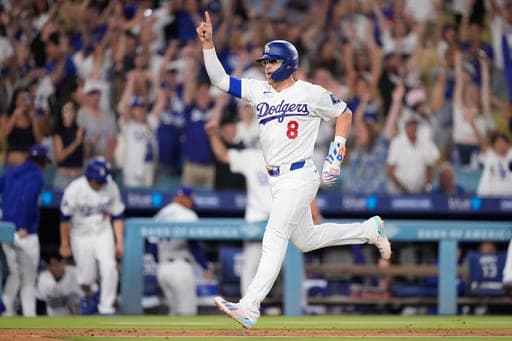 Los Angeles Dodgers' Kiké Hernández celebrates as he scores on a walk-off single by Tommy Edman during the 10th inning of a baseball game against the Pittsburgh Pirates, Friday, Aug. 21, 2026, in Los Angeles. (AP Photo/Mark J. Terrill) (AP Photo/Mark J. Terrill)