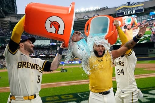 Milwaukee Brewers' Jackson Chourio is douced by Garrett Mitchell and William Contreras after hitting a walkoff hit during the ninth inning of Game 2 of a National League Divisional baseball playoff series against the San Diego Padres Sunday, Oct. 4, 2026, in Milwaukee. (AP Photo/Kayla Wolf) (AP Photo/Kayla Wolf)