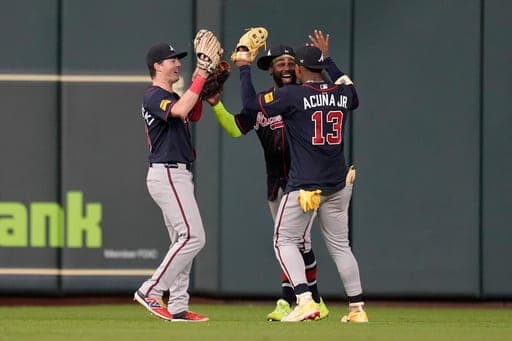Atlanta Braves left fielder Mike Yastrzemski (18), center fielder Michael Harris II (23), and right fielder Ronald Acuña Jr. (13) celebrate after winning a baseball game against the Houston Astros in Houston, Friday, Sept. 18, 2026. (AP Photo/Ashley Landis) (AP Photo/Ashley Landis)