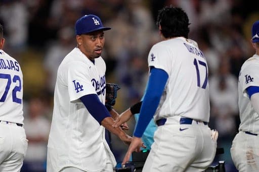 Los Angeles Dodgers pitcher Edwin Díaz, left, is congratulated by Shohei Ohtani after the Dodgers defeated the Milwaukee Brewers in a baseball game Friday, Aug. 14, 2026, in Los Angeles. (AP Photo/Mark J. Terrill) (AP Photo/Mark J. Terrill)