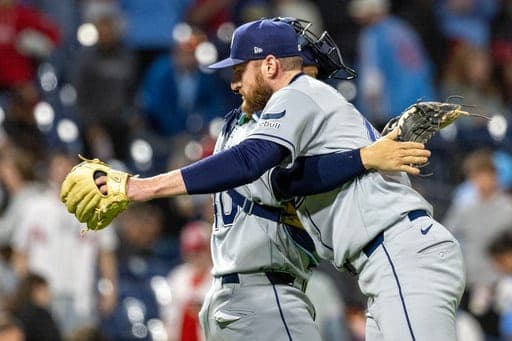 Tampa Bay Rays closing pitcher Bryan Baker, right, embraces' catcher Nick Fortes, left, after their team defeated the Philadelphia Phillies in a baseball game, Friday, Sept. 25, 2026, in Philadelphia. (AP Photo/Laurence Kesterson) (AP Photo/Laurence Kesterson)
