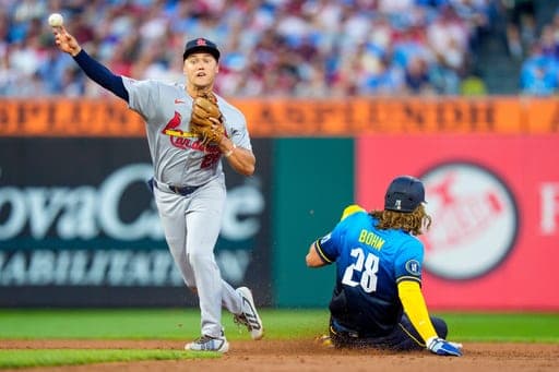 St. Louis Cardinals shortstop JJ Wetherholt, left, turns a double play as he gets Philadelphia Phillies' Alec Bohm, right, out at second base during the third inning of a baseball game, Friday, Aug. 21, 2026, in Philadelphia. (AP Photo/Chris Szagola) (AP Photo/Chris Szagola)