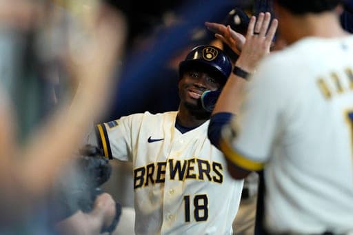 Milwaukee Brewers' Luis Lara is congratulated in the dugout after hitting a three-run home run for his first career home run during the eighth inning of a baseball game against the Seattle Mariners, Tuesday, Aug. 18, 2026, in Milwaukee. (AP Photo/Aaron Gash) (AP Photo/Aaron Gash)