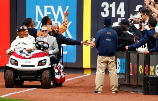 Hall of Famer CC Sabathia reaches out to touch a fan pose during his Monument Park induction ceremony before a baseball game between the New York Yankees and Baltimore Orioles, Friday, Sept. 25, 2026, in New York. (AP Photo/Noah K. Murray) (AP Photo/Noah K. Murray)