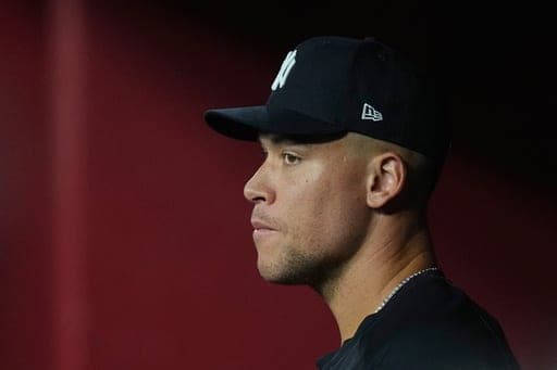 Injured New York Yankees' Aaron Judge watches the action on the field from the team dugout during the ninth inning of a baseball game against the Arizona Diamondbacks, Friday, Sept. 18, 2026, in Phoenix. (AP Photo/Ross D. Franklin) (AP Photo/Ross D. Franklin)