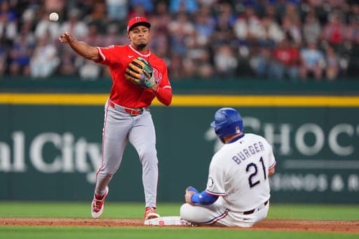 Los Angeles Angels second baseman Christian Moore, left, throws from second to first turning a double play against Texas Rangers' Jake Burger (21) and Danny Jansen during the third inning of a baseball game , Saturday, Aug. 22, 2026, in Arlington, Texas. (AP Photo/LM Otero) (AP Photo/LM Otero)
