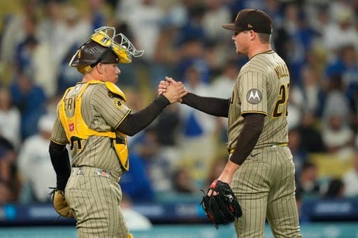 San Diego Padres catcher Freddy Fermin, left, and pitcher Mason Miller congratulate each other after the Padres defeated the Los Angeles Dodgers a baseball game Wednesday, Sept. 23, 2026, in Los Angeles. (AP Photo/Mark J. Terrill) (AP Photo/Mark J. Terrill)