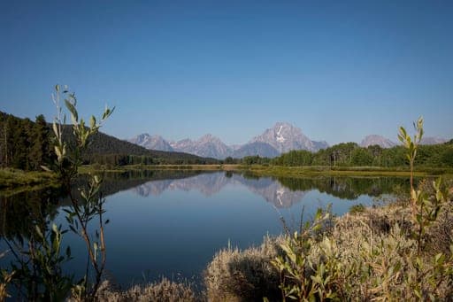 FILE - The Teton mountains reflect on Oxbow Bend in Grand Teton National Park in Moran, Wyo., Aug. 22, 2025. (AP Photo/Amber Baesler, File) (AP Photo/Amber Baesler)