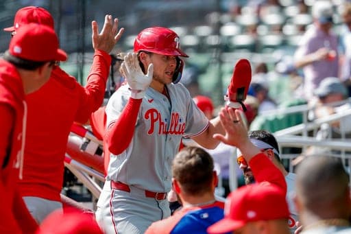 Philadelphia Phillies' Alec Bohm celebrates in the dugout after scoring against the Atlanta Braves during the eighth inning of a baseball game, Sunday, Sept. 13, 2026, in Atlanta. (AP Photo/Erik S. Lesser) (AP Photo/Erik S. Lesser)