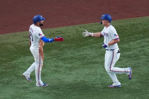 Texas Rangers' Corey Seager, right, celebrates his two-run home run with Ezequiel Duran after they both crossed home plate against the Tampa Bay Rays during the fifth inning of a baseball game Thursday, Sept. 3, 2026, in Arlington, Texas. (AP Photo/Julio Cortez) (AP Photo/Julio Cortez)