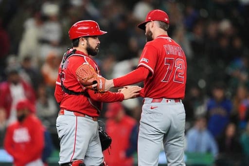 Los Angeles Angels catcher Travis d'Arnaud, left, greets relief pitcher Luke Murphy, right, as they celebrate a win over the Seattle Mariners in a baseball game, Friday, Sept. 25, 2026, in Seattle. (AP Photo/Lindsey Wasson) (AP Photo/Lindsey Wasson)