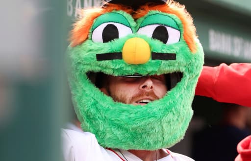 Off the wall: Red Sox celebrate home runs by wearing the head of mascot Wally, the Green Monster
