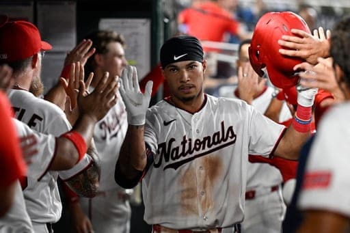 Washington Nationals' Daylen Lile is greeted by teammates in the dugout after hitting a two-run home run during the fifth inning of a baseball game against the Miami Marlins, Monday, Aug. 31, 2026, in Washington. (AP Photo/John McDonnell) (AP Photo/John McDonnell)