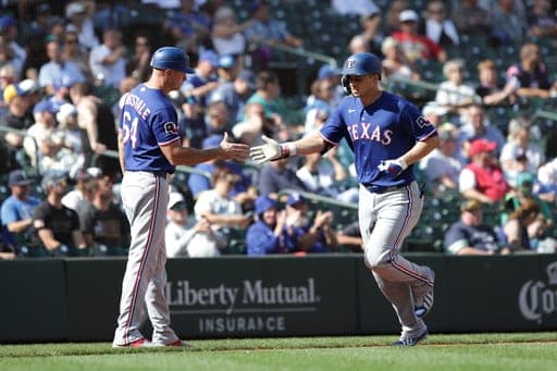 Texas Rangers Corey Seager, right, celebrates with third base coach Corey Ragsdale after hitting a solo home run off Seattle Mariners relief pitcher Gabe Speier during the eighth inning of a baseball game, Wednesday, Sept. 9, 2026, in Seattle. (AP Photo/Jason Redmond) (AP Photo/Jason Redmond)