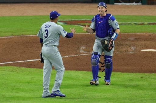 Los Angeles Dodgers catcher Will Smith, right, congratulates closing pitcher Edwin Díaz (3) after winning Game 4 of baseball's National League Division Series against the Atlanta Braves, Wednesday, Oct. 7, 2026, in Atlanta. (AP Photo/Colin Hubbard) (AP Photo/Colin Hubbard)