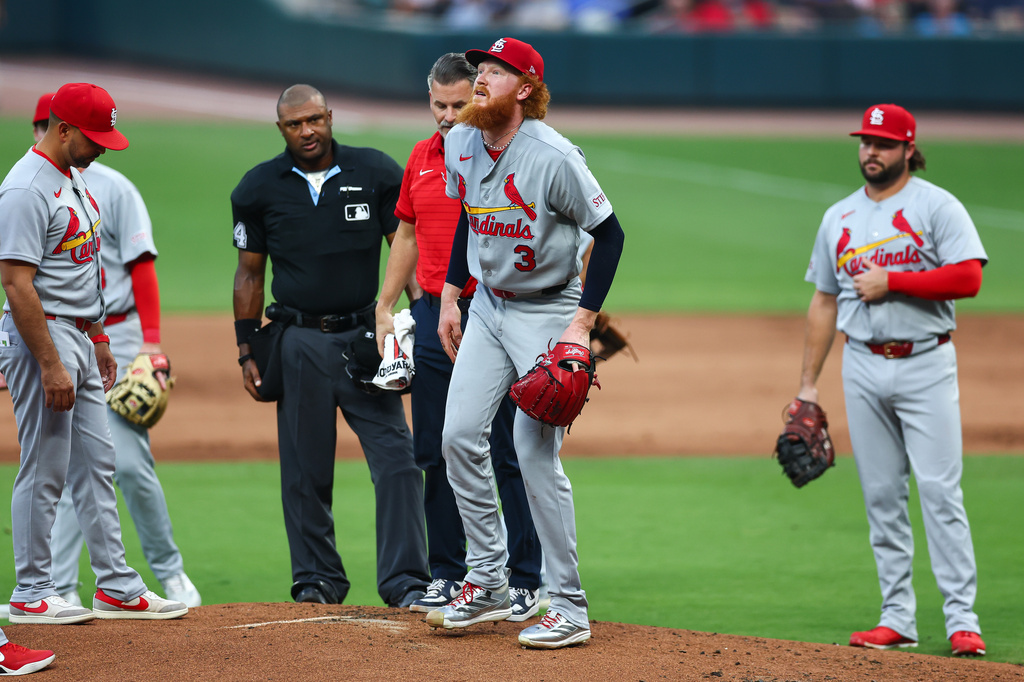 Dustin May reacts with manager Oliver Marmol and a trainer after an injury in July.