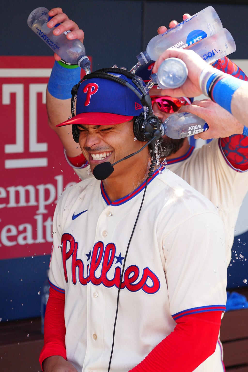 Phillies pitcher Jesús Luzardo is doused by teammates in the dugout after a win over the Braves.