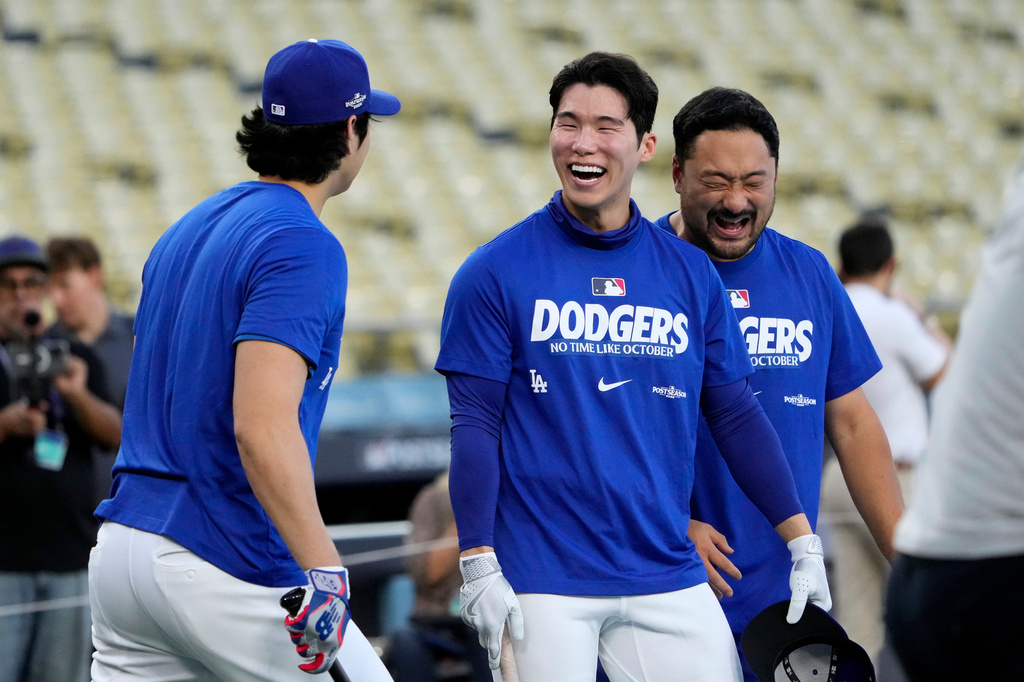 Dodgers teammates Shohei Ohtani and Hyeseong Kim laugh during a workout before the National League Division Series.