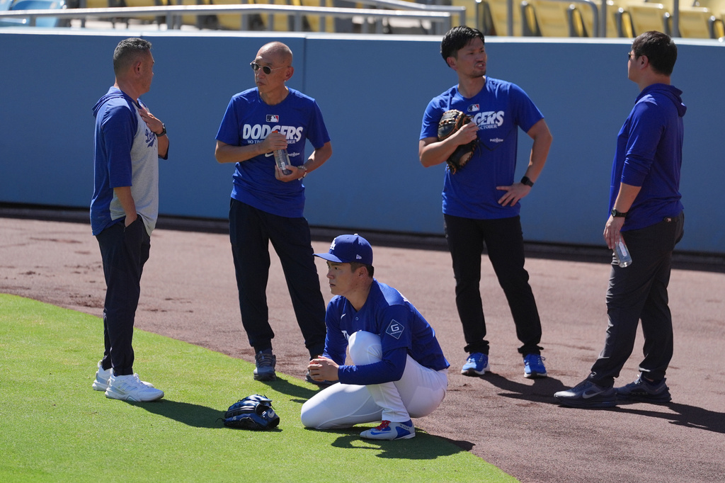 Dodgers pitcher Yoshinobu Yamamoto kneels before Game 2 of the National League Division Series.
