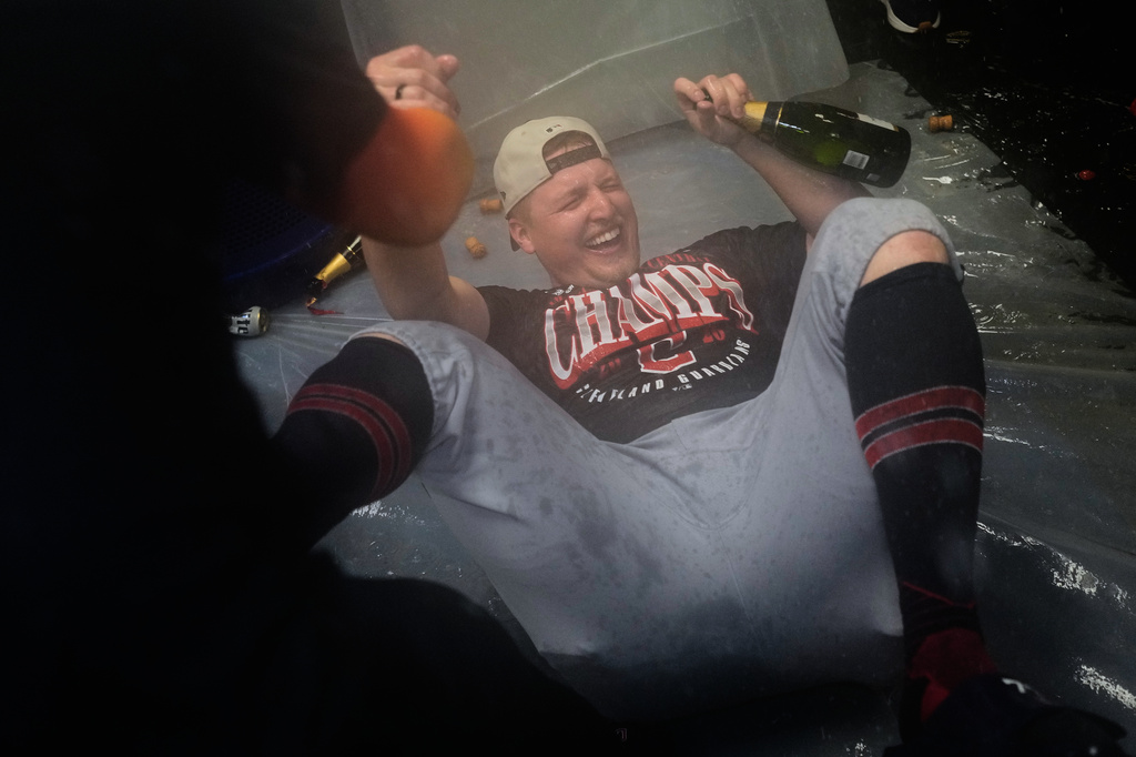 Guardians pitcher Parker Messick celebrates in the clubhouse after Cleveland clinched the American League Central.