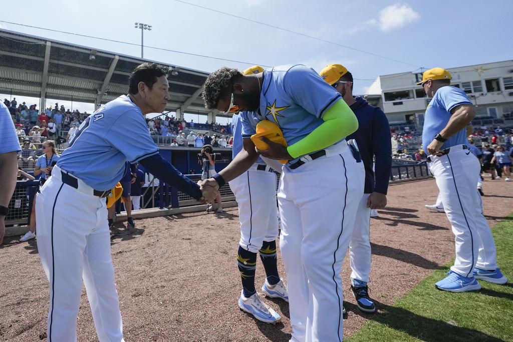 Junior Caminero greets Japan manager Hideki Kuriyama before a spring training game in 2024.