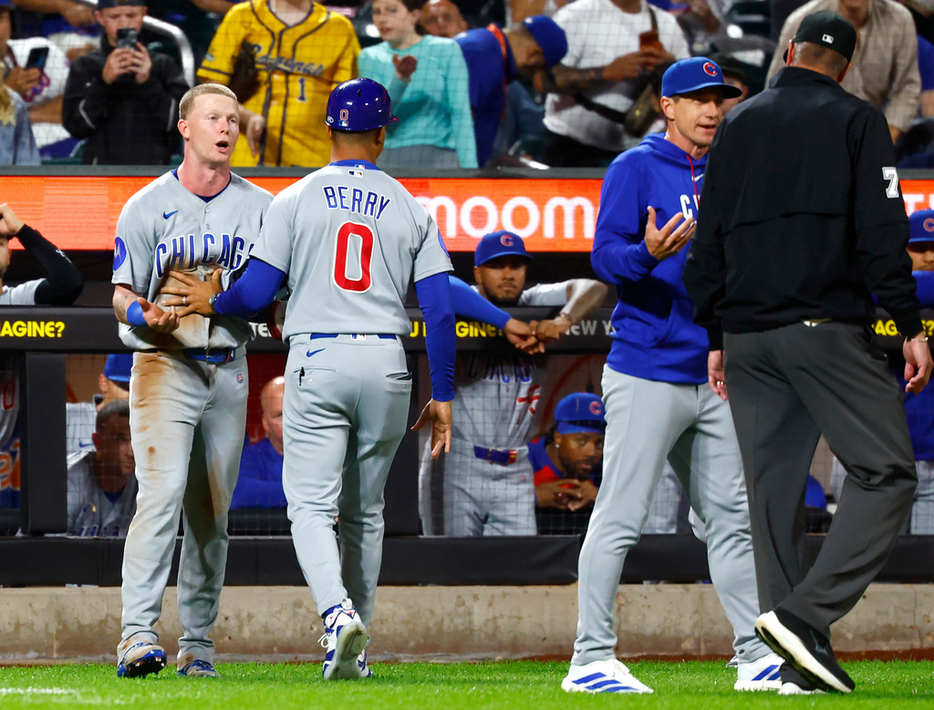 Cubs center fielder Pete Crow-Armstrong and manager Craig Counsell argue with an umpire.